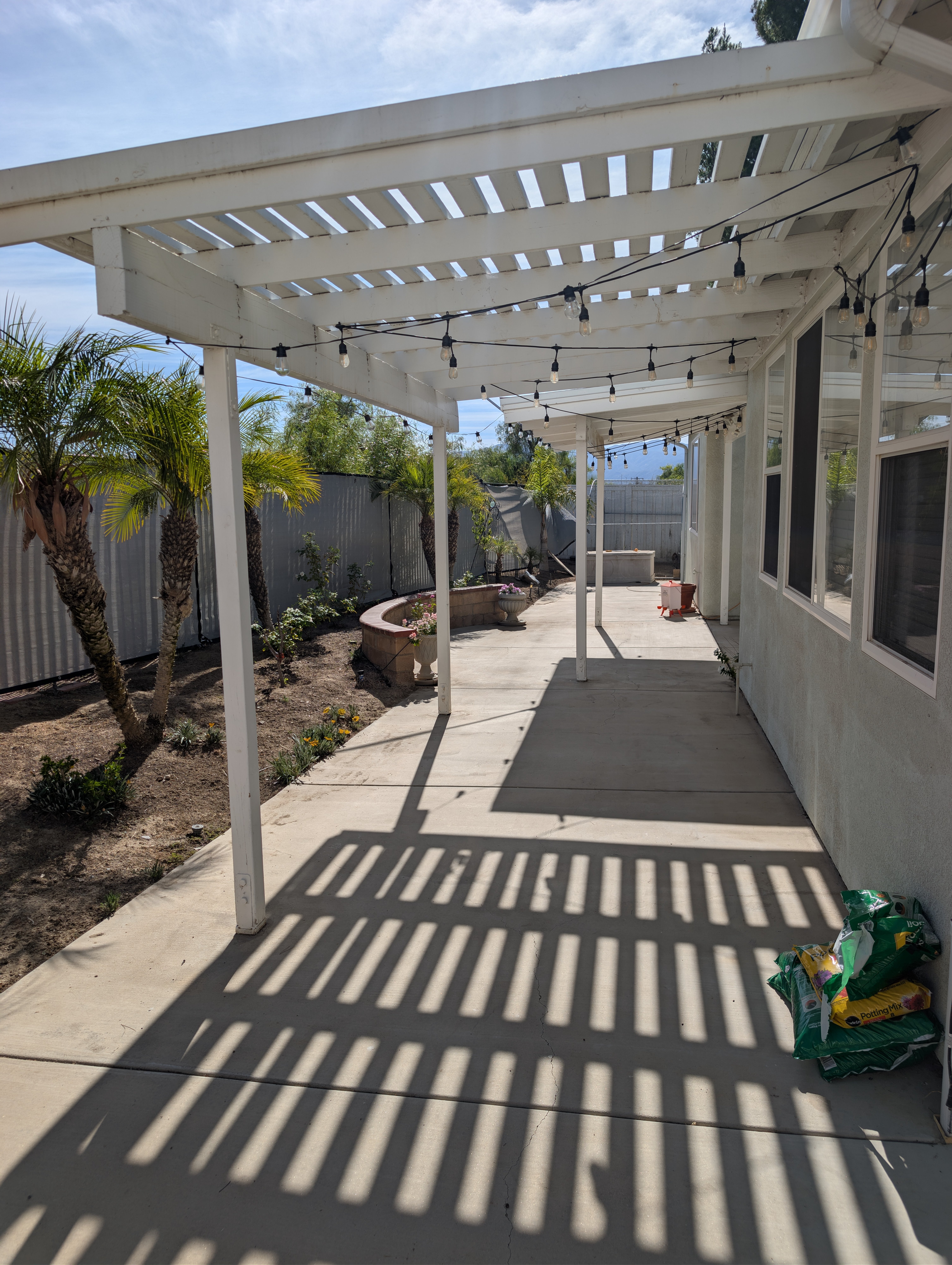 Backyard pergola with string lights — Soleil Levant Care